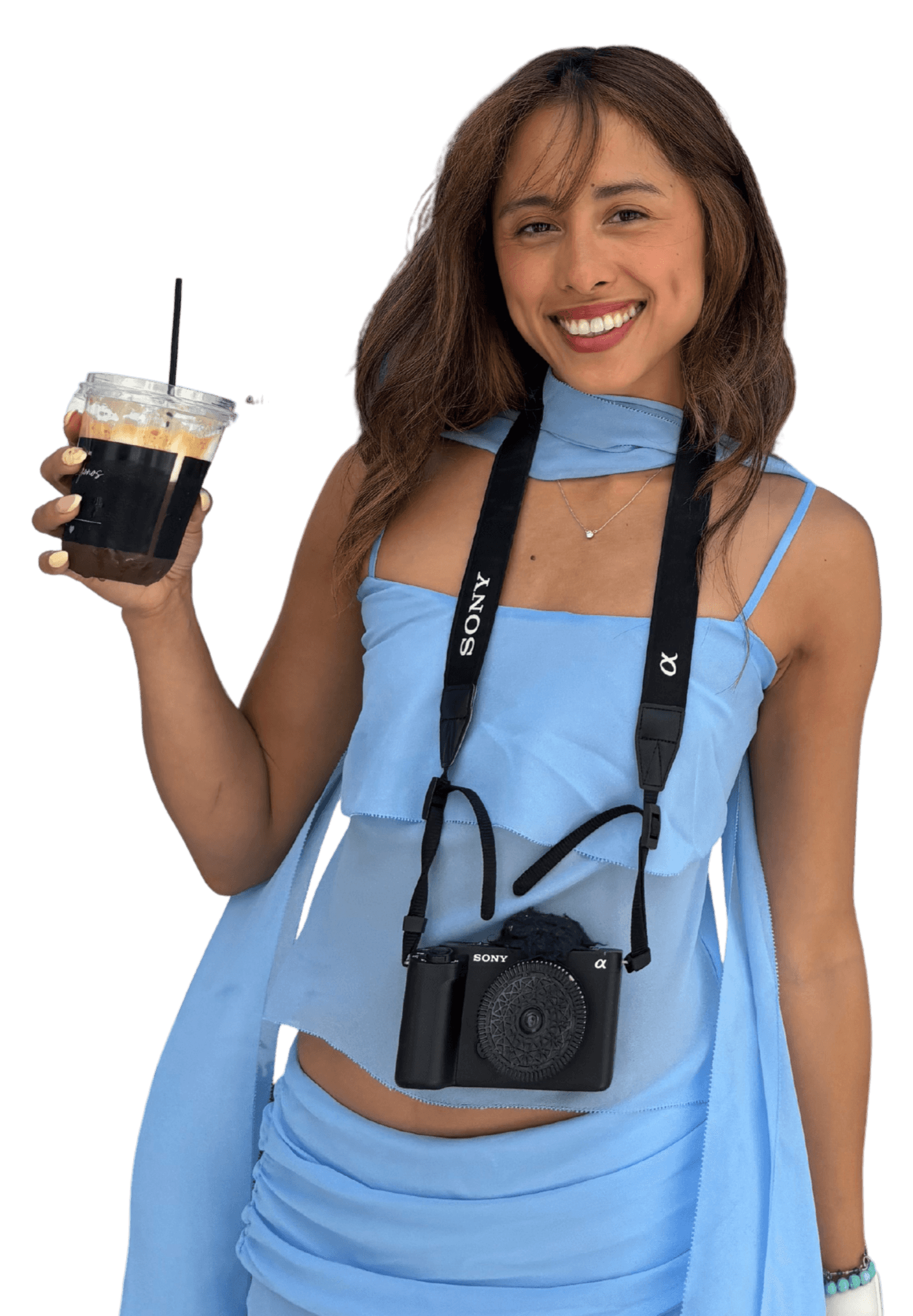 Maricris Bonzo holding an iced coffee with a camera around her neck
